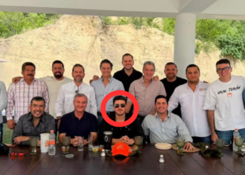 Guerra Sucia De Samuel Por Las Votaciones - Regios En México Group of Men Posing for a Photo Around a Long Table Outdoors; the Central Man Wears Sunglasses and Sits with the Group Circled in Red. - Regios En México